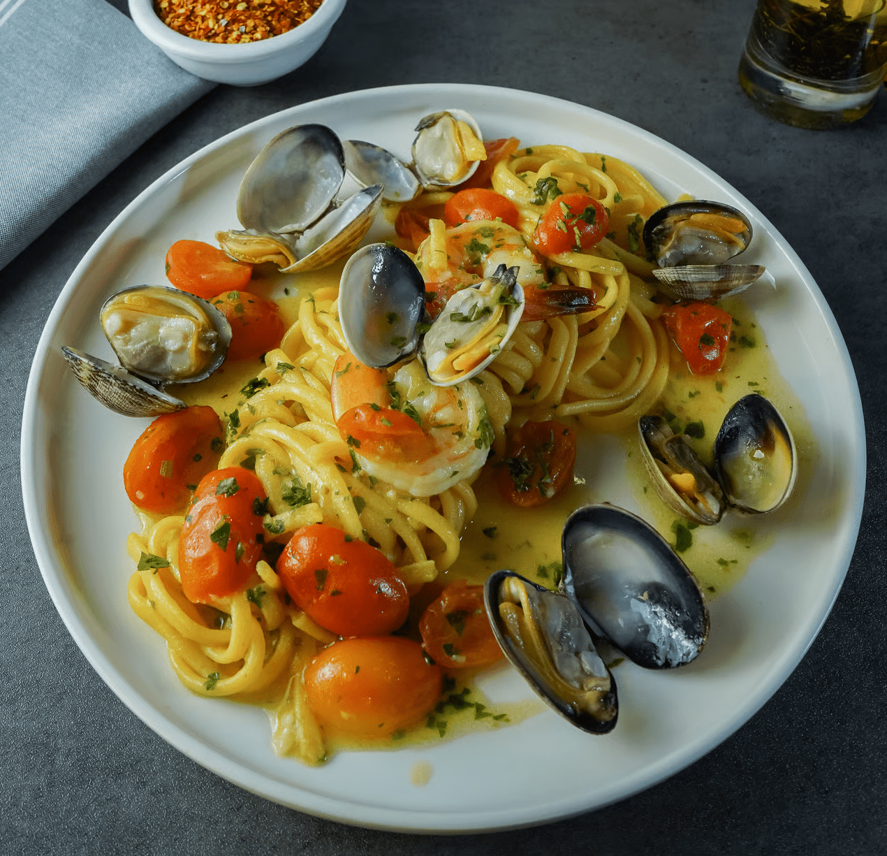 image of pasta with mussels and tomatoes on a plate