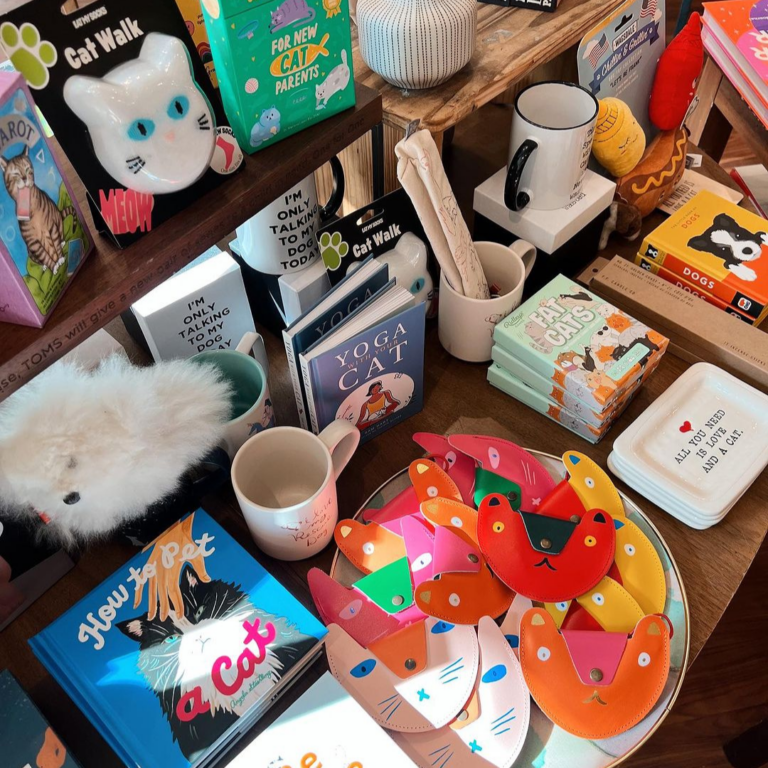 collection of cat-themed items, trinkets & books at a boutique