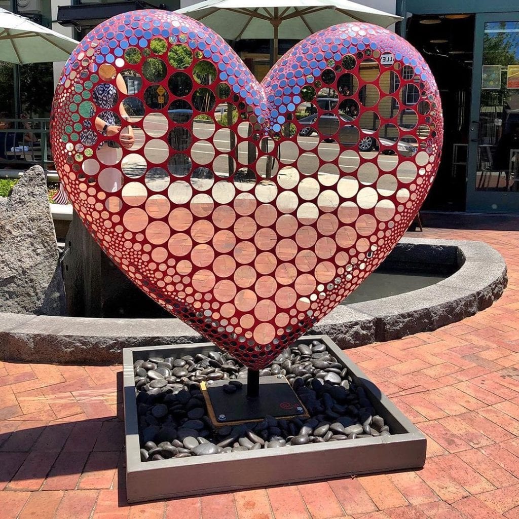 public art installation of a large heart covered in mirrors